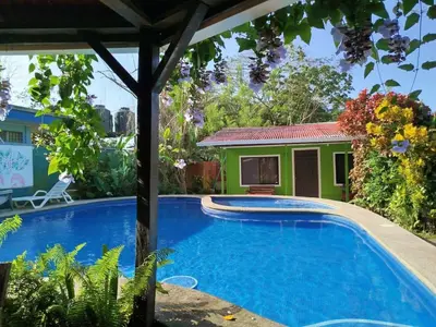 a swimming pool in front of a house at Casa Selvamar, un oasis en la selva in Tortuguero