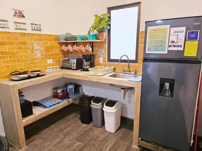 a kitchen with a sink and a refrigerator at Casa Selvamar, un oasis en la selva in Tortuguero