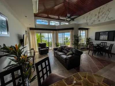 a living room with a couch and a table at Beachfront Exotic Family Groups Retreat Wedding in Jacó