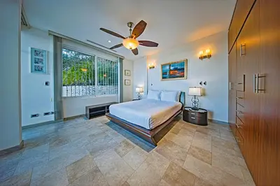 a bedroom with a bed and a ceiling fan at Modern 4 Bedroom Infinity Pool Beach, Sunset, in Playa Hermosa