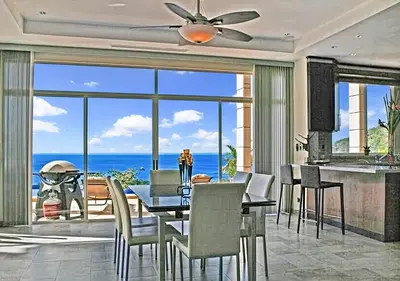 a dining room with a table and a view of the ocean at Modern 4 Bedroom Infinity Pool Beach, Sunset, in Playa Hermosa