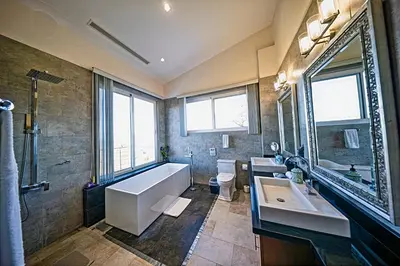 a bathroom with a large tub and a sink and a tub at Modern 4 Bedroom Infinity Pool Beach, Sunset, in Playa Hermosa