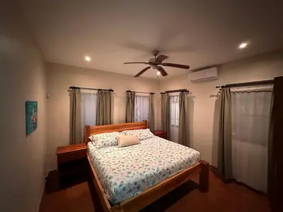 a bedroom with a bed and a ceiling fan at Casa Veranera in Playa Grande