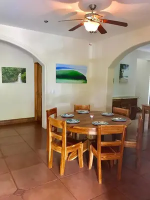 a dining room with a wooden table and chairs at Casa Veranera in Playa Grande