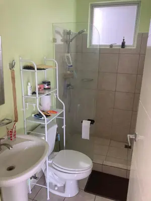 a bathroom with a shower and a toilet and a sink at 2 BR Condo near San Jose, Costa Rica in Santa Cruz