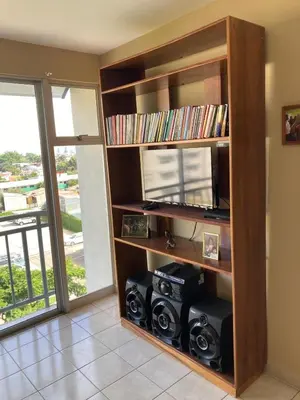 a book shelf with audio equipment in a room with a window at 2 BR Condo near San Jose, Costa Rica in Santa Cruz