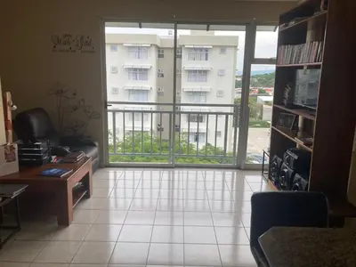 a living room with a view of a building at 2 BR Condo near San Jose, Costa Rica in Santa Cruz