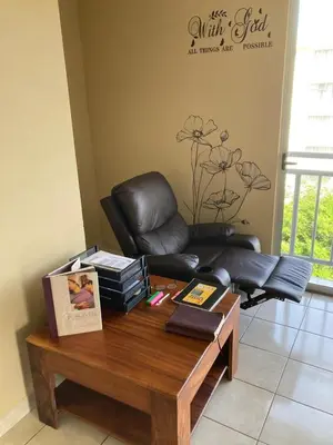 a living room with a leather chair and a coffee table at 2 BR Condo near San Jose, Costa Rica in Santa Cruz