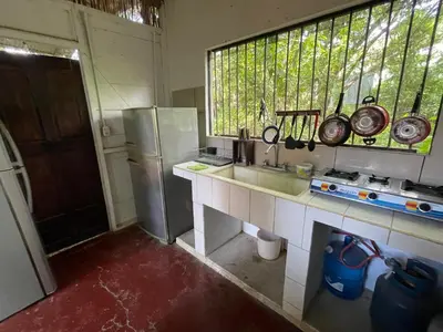 a kitchen with a counter and a sink and a window at Noni Garden in Tamarindo