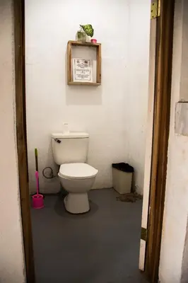 a bathroom with a toilet in a room at Noni Garden in Tamarindo
