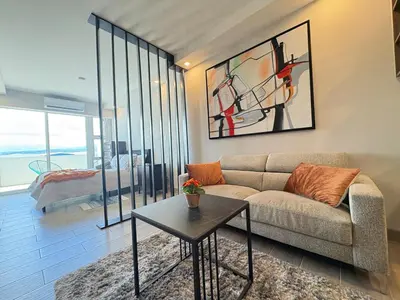 a living room with a couch and a table at Premium Apartment In Be Cariari in Heredia