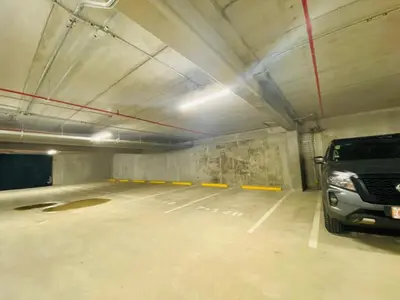 a parking garage with a car parked in it at Premium Apartment In Be Cariari in Heredia