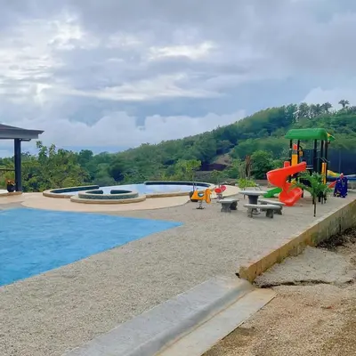 a pool with a playground with a slide at Casa Brisa house in the mountains 15 minutes from the beach in Nicoya