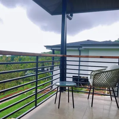a balcony with a table and a chair and a view at Casa Brisa house in the mountains 15 minutes from the beach in Nicoya