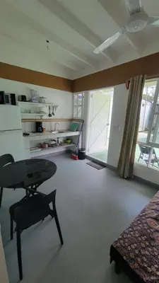 a living room with a table and a room with a window at Residencial Oasis in Sámara