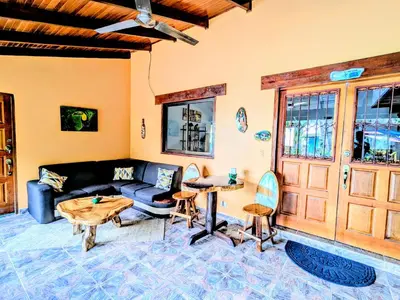 a living room with a couch and a table at Intimate Earthy Vibe - Bedroom in a Tropical Paradise in Herradura