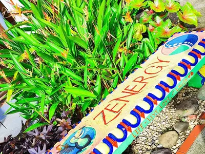 a sign for a garden in front of a plant at Intimate Earthy Vibe - Bedroom in a Tropical Paradise in Herradura