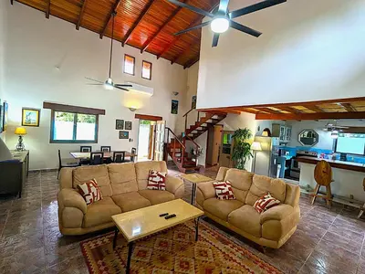 a living room with two couches and a table at Intimate Earthy Vibe - Bedroom in a Tropical Paradise in Herradura