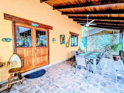 a dining room with a table and chairs at Lovely Tropical Ensuite Bedroom - Pool AC Hot Water in Herradura