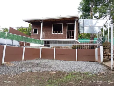 a fence in front of a house at Cabaña Renaciendo in Turrialba