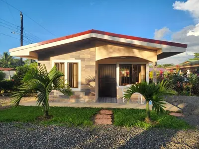 a small house with two palm trees in front of it at La Fortuna, Fluca House 1 in Fortuna