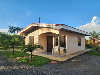 a small house with a porch and a table at La Fortuna, Fluca House 1 in Fortuna