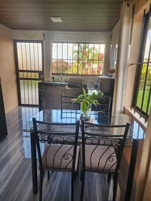 a dining room with a glass table and chairs at La Fortuna, Fluca House 1 in Fortuna