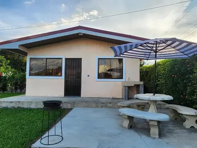 a house with a picnic table and an umbrella at La Fortuna, Fluca House 1 in Fortuna