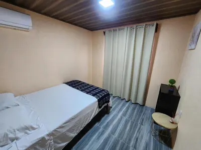 a small bedroom with a bed and a window at La Fortuna, Fluca House 1 in Fortuna