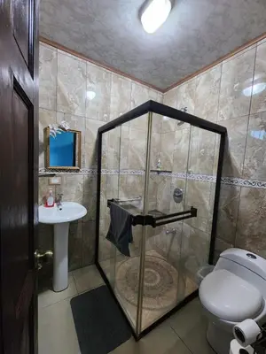 a bathroom with a shower with a toilet and a sink at La Fortuna, Fluca House 2 in Fortuna