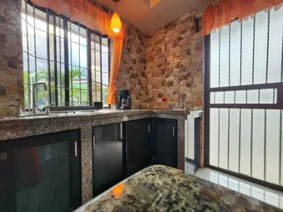 a kitchen with a counter and some windows at La Fortuna, Fluca House 2 in Fortuna
