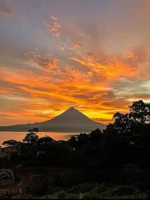 a view of a mountain with a sunset in the background at La Fortuna, Fluca House 3 in Fortuna