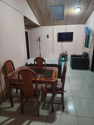 a dining room with a table and chairs and a couch at La Fortuna, Fluca House 3 in Fortuna