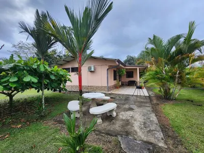 a house with a table and two benches in the yard at La Fortuna, Fluca House 3 in Fortuna