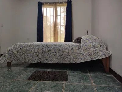 a bed sitting in a room with a mattress at Hostel Cora Chia in Pedregal