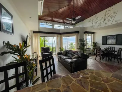 a living room with a couch and a table at Beachfront Balcony Sunset 2B in Jacó