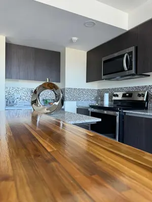 a kitchen with a hard wood floor and a kitchen with a sink at Penthouse San José Costa Rica in San José