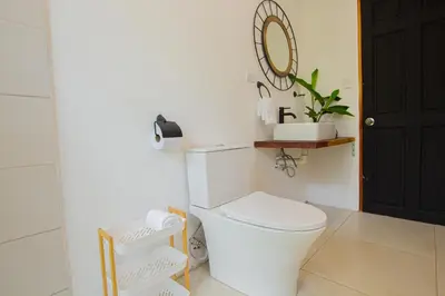 a bathroom with a white toilet and a mirror at Monte y Alma Monteverde in Cebadilla