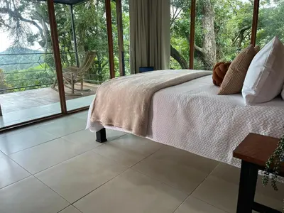 a bedroom with a bed and a view of a porch at Monte y Alma Monteverde in Cebadilla