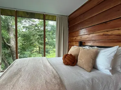 a bed with a teddy bear sitting on top of it at Monte y Alma Monteverde in Cebadilla