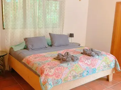a bed with two stuffed animals on top of it at Casa Redonda Tranquil House 15 Minutes from Samara by Car in Nicoya
