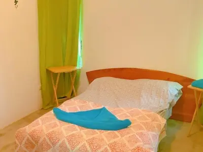 a bedroom with a bed with blue shoes on it at Casa Redonda Tranquil House 15 Minutes from Samara by Car in Nicoya