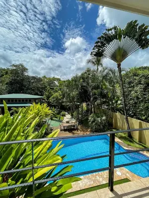 a view from the balcony of a resort with a swimming pool at Beachfront Terrace Sunset 3B in Jacó