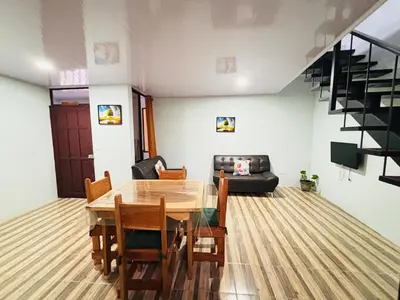 a dining room with a wooden table and chairs at SUA Luxury Arenal Volcano View Apartments in Fortuna
