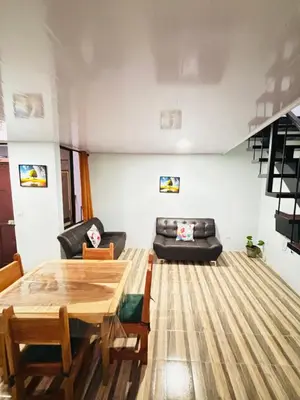 a living room with a table and a couch at SUA Luxury Arenal Volcano View Apartments in Fortuna