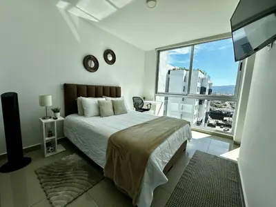 a bedroom with a large bed and a large window at Luxury 12th Floor Apartment with Views - Downtown San Jose Pool and Gym in San José