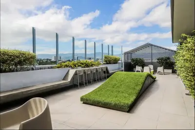a rooftop patio with a green lawn on a building at Luxury 12th Floor Apartment with Views - Downtown San Jose Pool and Gym in San José