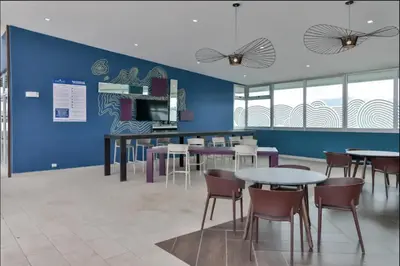 a dining room with tables and chairs and a blue wall at Luxury 12th Floor Apartment with Views - Downtown San Jose Pool and Gym in San José
