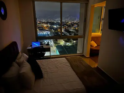 a bedroom with a bed and a window with a view at Luxury 12th Floor Apartment with Views - Downtown San Jose Pool and Gym in San José