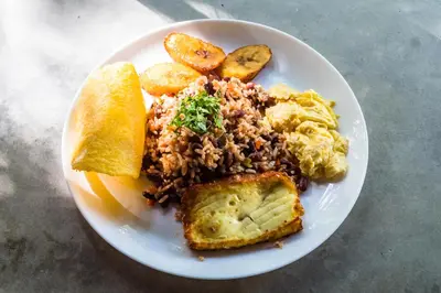 a plate of food with rice and bread and toast at The Sunset Shack in Nosara